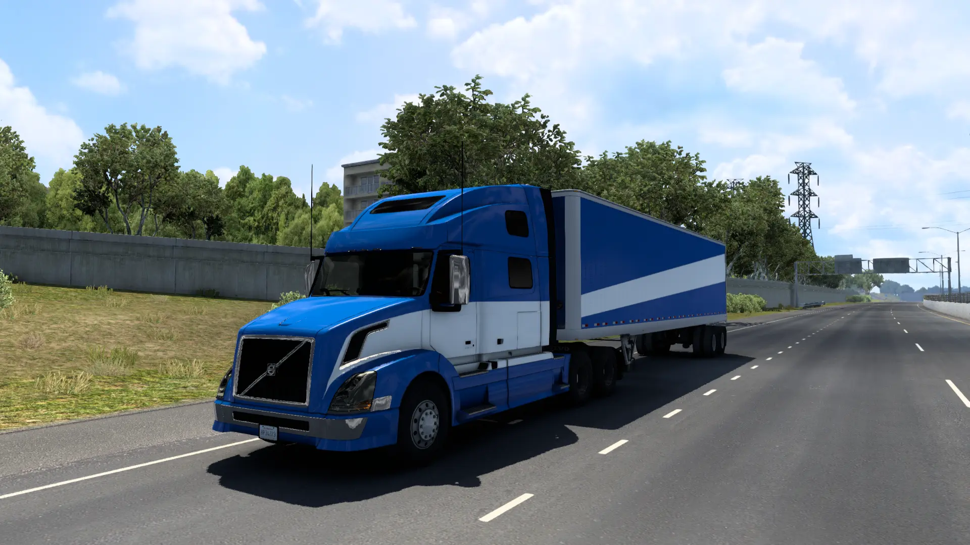 a blue semi truck driving down the road